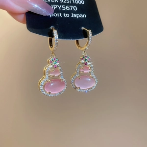Detailed macro view of 14k gold plated gourd earrings with pink zircon and 925 silver base