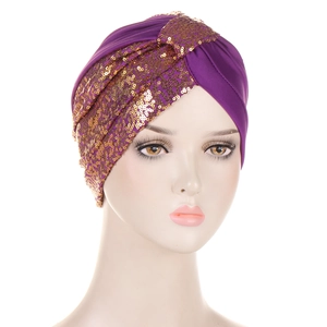 Close-up of purple sequined turban featuring golden metallic circular accents and soft fabric