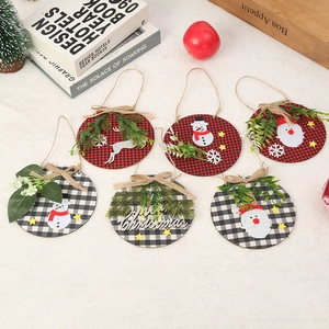 Detailed view of six plaid wooden Christmas ornaments with festive appliques and greenery