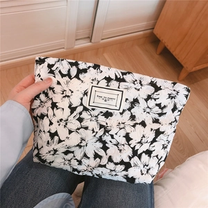 Detail of floral bubble cotton pouch featuring white woven label with Time To Party text