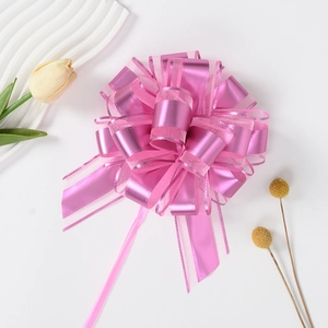 Macro detail of large pink organza and metallic ribbon bow for gift packaging