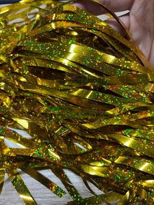 Macro shot of shimmering gold tinsel curtains with laser glitter effect for party backdrop