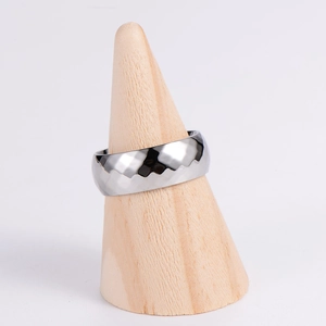 Faceted mobius ring in silver stainless steel displayed on a wooden cone stand