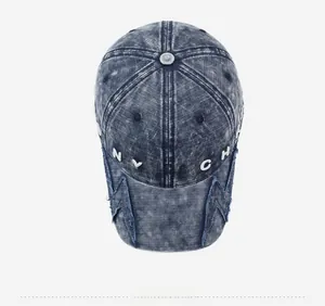 Top down view of distressed blue denim baseball cap with NYFTCH embroidery and lightning patches