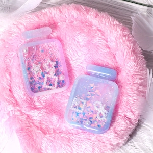 Detailed view of pink and purple gradient perfume bottle resin shaker molds with glitter