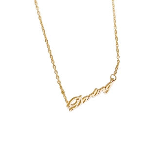 Minimalist gold titanium steel necklace with a script Darling pendant on a clean white background