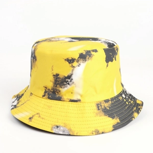 Detail of yellow and black tie-dye bucket hat with classic flat top and wide brim