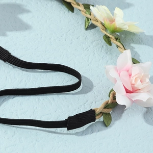 Bohemian floral headband with pink and cream fabric roses on a braided cord base