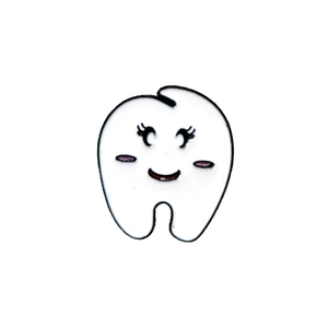 Close-up of cute cartoon tooth enamel pin with smiling face and pink blush details