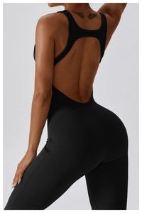 Detail of cross-back straps and open back design on black flared yoga jumpsuit