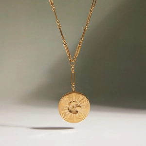 18K gold plated stainless steel Y-necklace featuring camellia flower sunburst coin pendant
