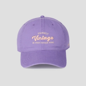 Detail of premium purple cotton baseball cap with intricate vintage embroidery and stitching