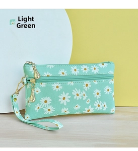 Detail of light green floral small clutch with double zippers and a wristlet strap