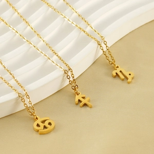 Detailed view of three 18K gold-plated zodiac necklaces with Cancer and Capricorn pendants