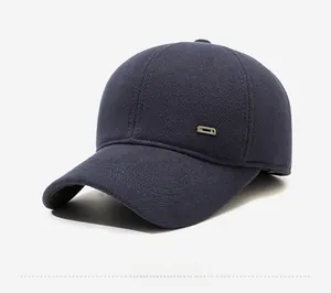 Close-up of navy blue winter baseball cap showing thick wool texture and metal side buckle