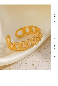 Close-up of 18K gold plated Cuban link ring with hammered texture on silk background