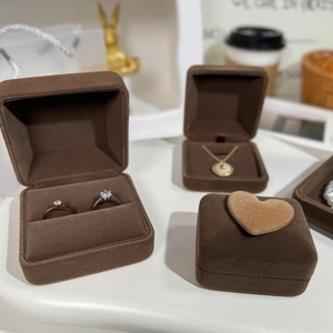 Brown velvet jewelry boxes for rings and necklaces with plush heart detail texture