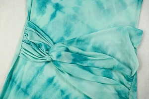 Detailed view of the turquoise tie-dye mesh dress showing the waist knot and pleated texture