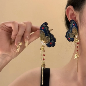 Vintage gold embroidered butterfly earrings with blue wings and red tassel drops