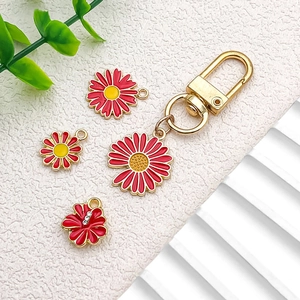 DIY gold lobster clasp keychain set with red and yellow enamel flower charms and rhinestones