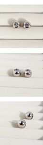 Detail shot of round cubic zirconia earrings with visible S925 hallmark on the silver post