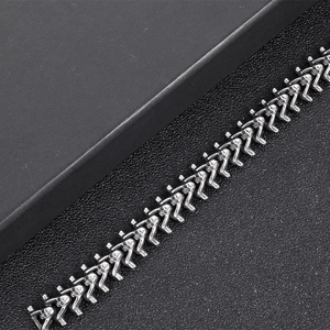 Macro shot of gothic stainless steel skeleton spine link bracelet on black leather