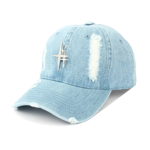 Close-up of distressed denim baseball cap with silver star studs and vintage holes