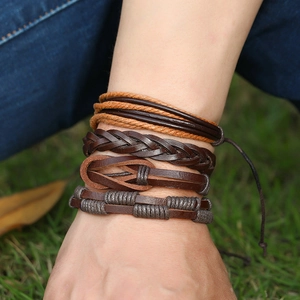 Close-up of four-piece vintage braided leather bracelets with metal details on wrist