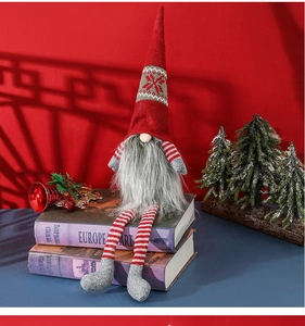 Detailed view of a Christmas gnome doll with a red snowflake hat and striped long legs