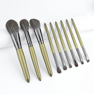 Close-up of a 10-piece olive green makeup brush set with dark grey ferrules on white
