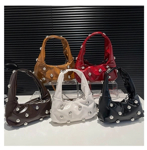 Detailed arrangement of five studded faux leather underarm bags in various chic colors