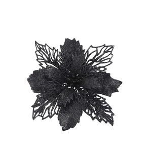 Macro view of black glitter artificial Christmas flower with hollowed-out petal design