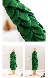 Detail of green felt Christmas tree ornament with wooden star and base in Nordic style