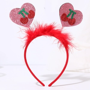 Detail of red feather headband with pink glitter hearts and cherry patterns for party