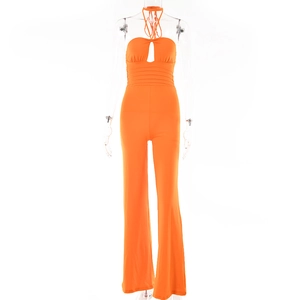 Detail view of orange halter neck jumpsuit with front cut-out and ruched waist design