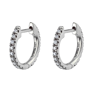 Macro shot of silver huggie hoop earrings featuring pavé set sparkling clear zircons