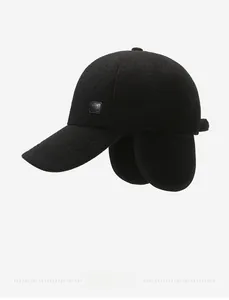Detail of winter baseball cap with fold-down earflaps in thick black wool blend fabric