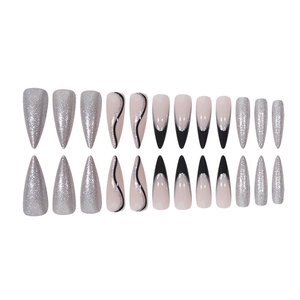 Long stiletto press-on nails with silver glitter and black French lines on nude base