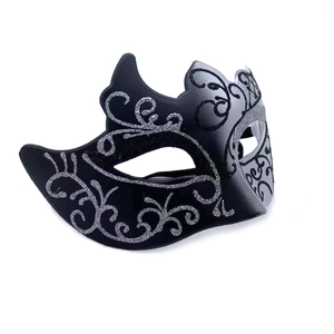 Detailed view of Venetian masquerade mask in black with silver glitter floral patterns