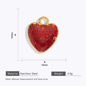 Detail view of a 19mm red heart charm in stainless steel with 18k gold plating