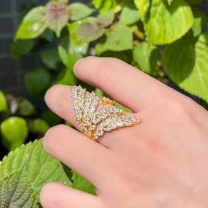 Detailed shot of a gold angel wing ring with marquise-cut cubic zirconia and pavé stones