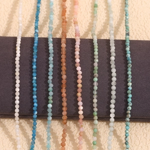 Macro detail of multi-colored faceted natural stone beads on an 18K gold plated chain