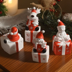 Christmas snowman and reindeer figurines on gift box base, festive home decor set