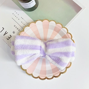 Detail of soft purple and white striped coral fleece headband with a large bow design