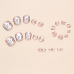 Macro detail of nude pink cat-eye press-on toe nails with silver wave line and french tip