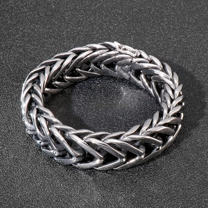 Detailed view of silver stainless steel thick curb chain bracelet for men with V-shaped link
