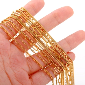 Detailed close-up of 18k gold plated stainless steel chains held by hand for jewelry DIY