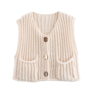 Detail of cream chunky knit vest featuring V-neckline and marbled buttons with pockets