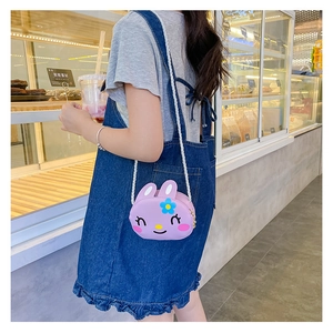 Detail of cute purple rabbit crossbody bag with white woven strap for girls