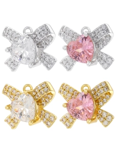 Detail showing four styles of bow heart pendants with pink and white crystal stones